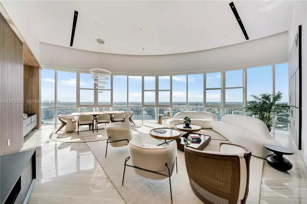 a view of a hallway with wooden floor and living room