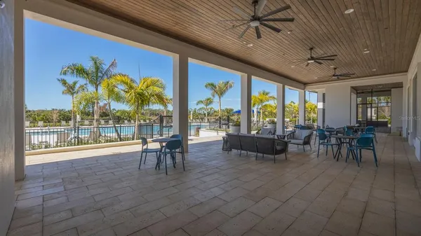 a view of swimming pool with outdoor seating and a patio