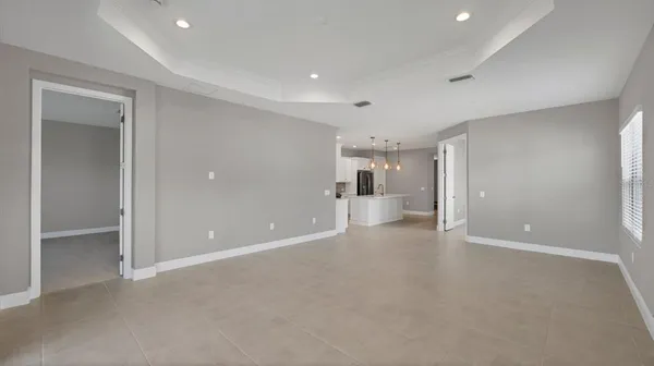 a large kitchen with white cabinets and stainless steel appliances