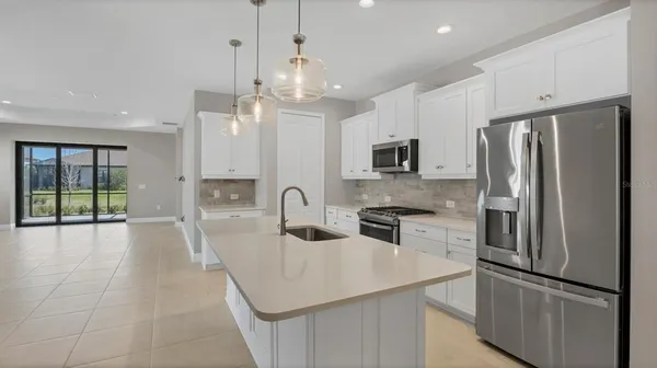 a kitchen with cabinets a sink and stainless steel appliances