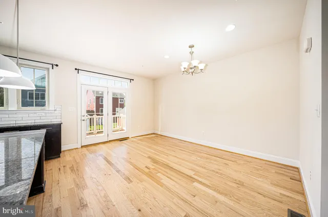 a view of workspace with wooden floor and a ceiling fan
