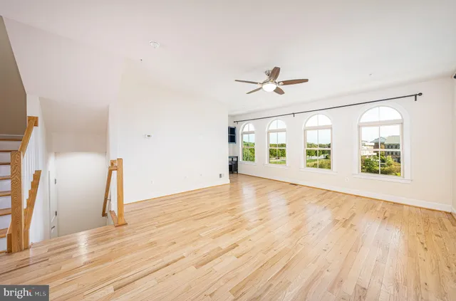 a view of an empty room with a fireplace and a window
