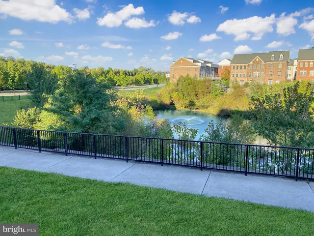 a view of a bedroom with wooden floor and windows