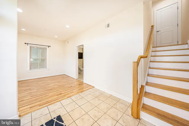 a view of a livingroom with wooden floor and windows