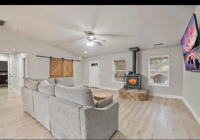 a living room with furniture and kitchen view