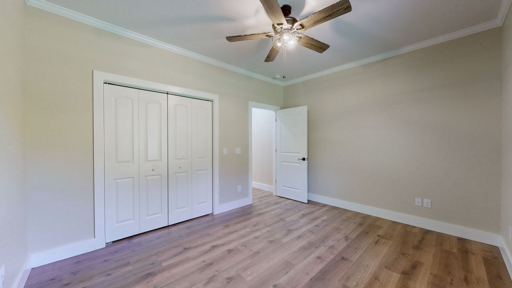 865 Alman Cemetery Road Paris, TN 38242 - Photo 25 of 41 an empty room with wooden floor fan and windows