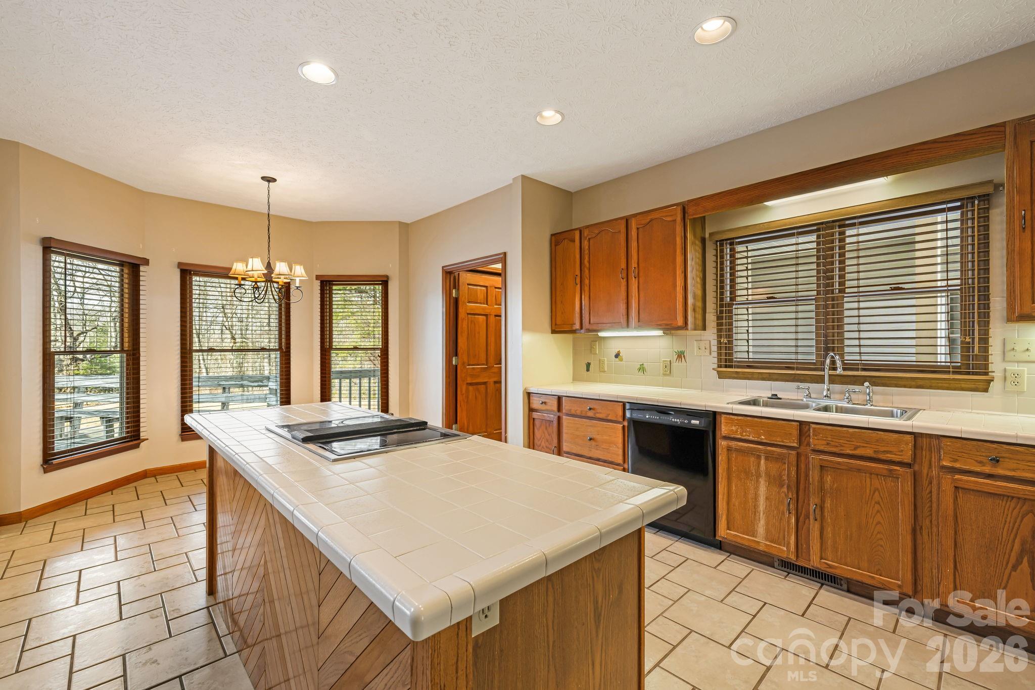 427 McCoy Cove Road Black Mountain, NC 28711 - Photo 13 of 47 a kitchen with stainless steel appliances granite countertop a sink stove and cabinets