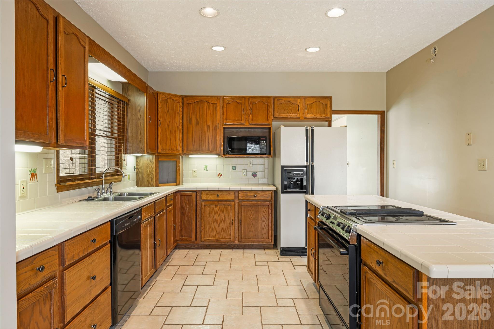 427 McCoy Cove Road Black Mountain, NC 28711 - Photo 14 of 47 a kitchen with stainless steel appliances granite countertop a sink a stove a refrigerator and cabinets