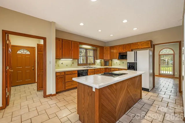 a kitchen with stainless steel appliances granite countertop a refrigerator and a sink