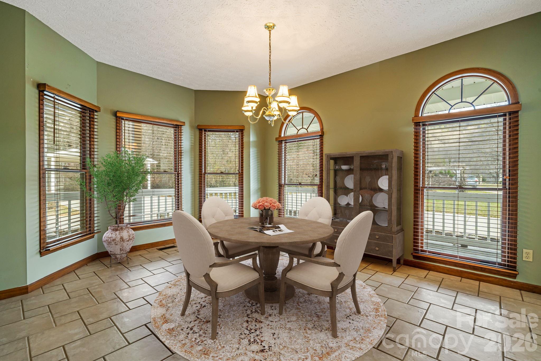 427 McCoy Cove Road Black Mountain, NC 28711 - Photo 16 of 47 a dining room with furniture a chandelier and wooden floor