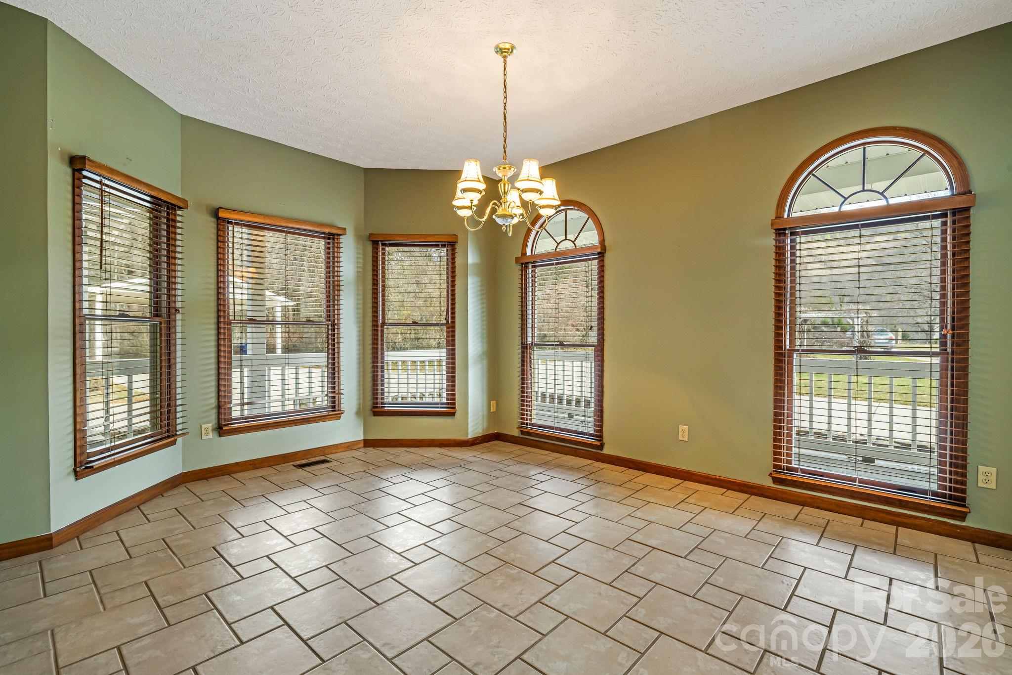 427 McCoy Cove Road Black Mountain, NC 28711 - Photo 17 of 47 a view of an empty room with window chandelier