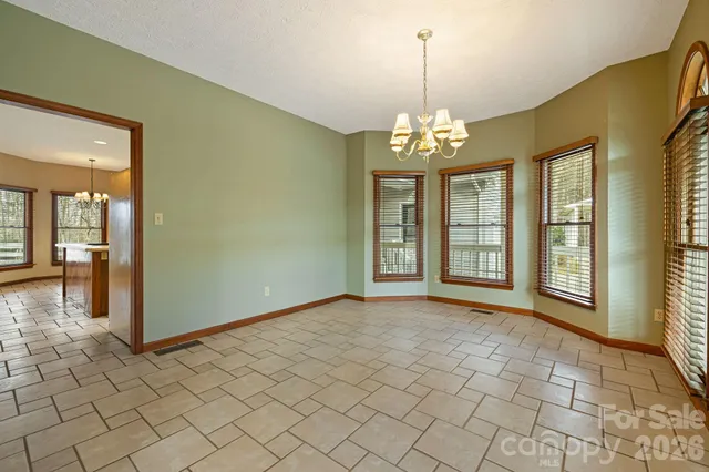 an empty room with windows and entrance