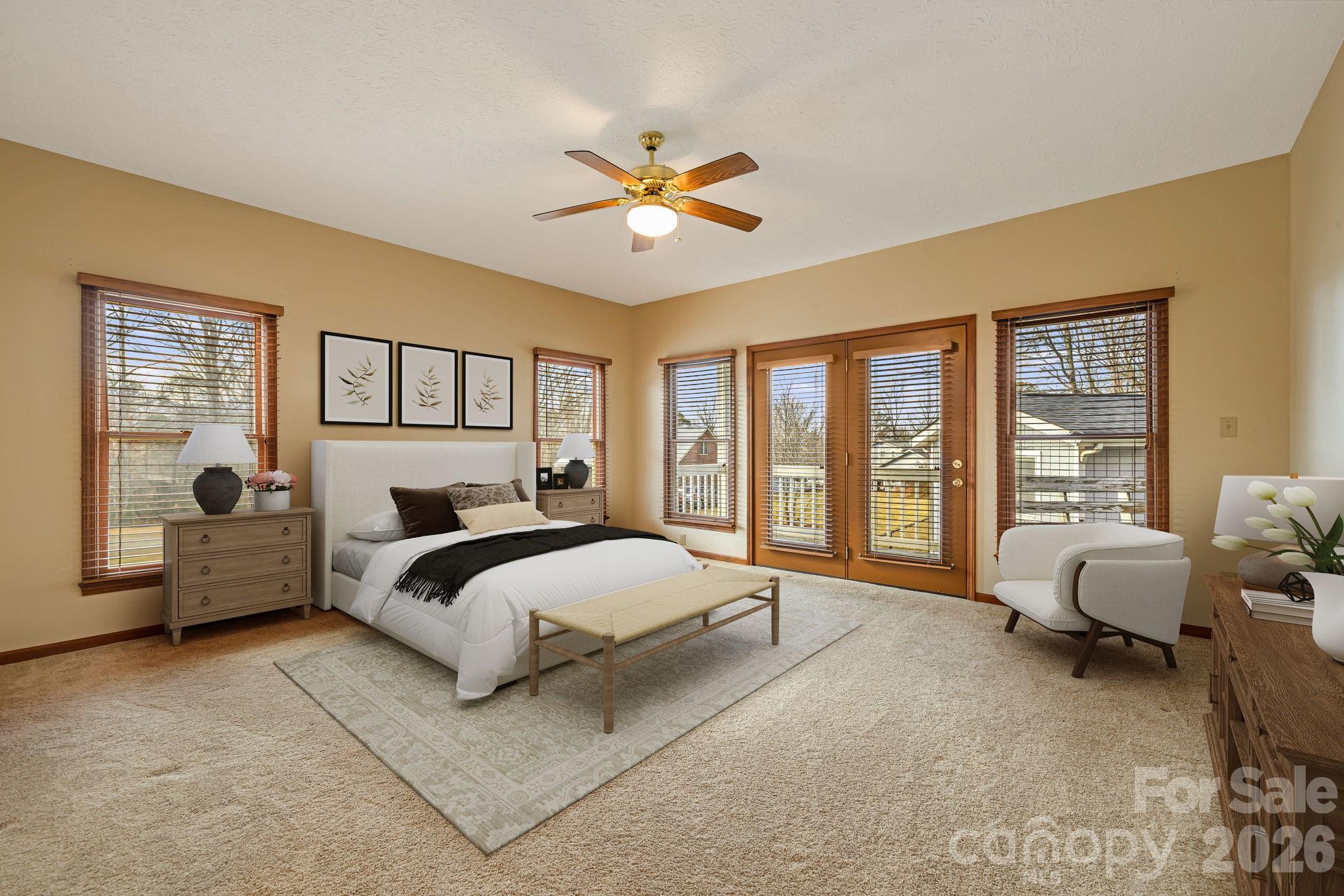 427 McCoy Cove Road Black Mountain, NC 28711 - Photo 19 of 47 a spacious bedroom with a bed couch and windows