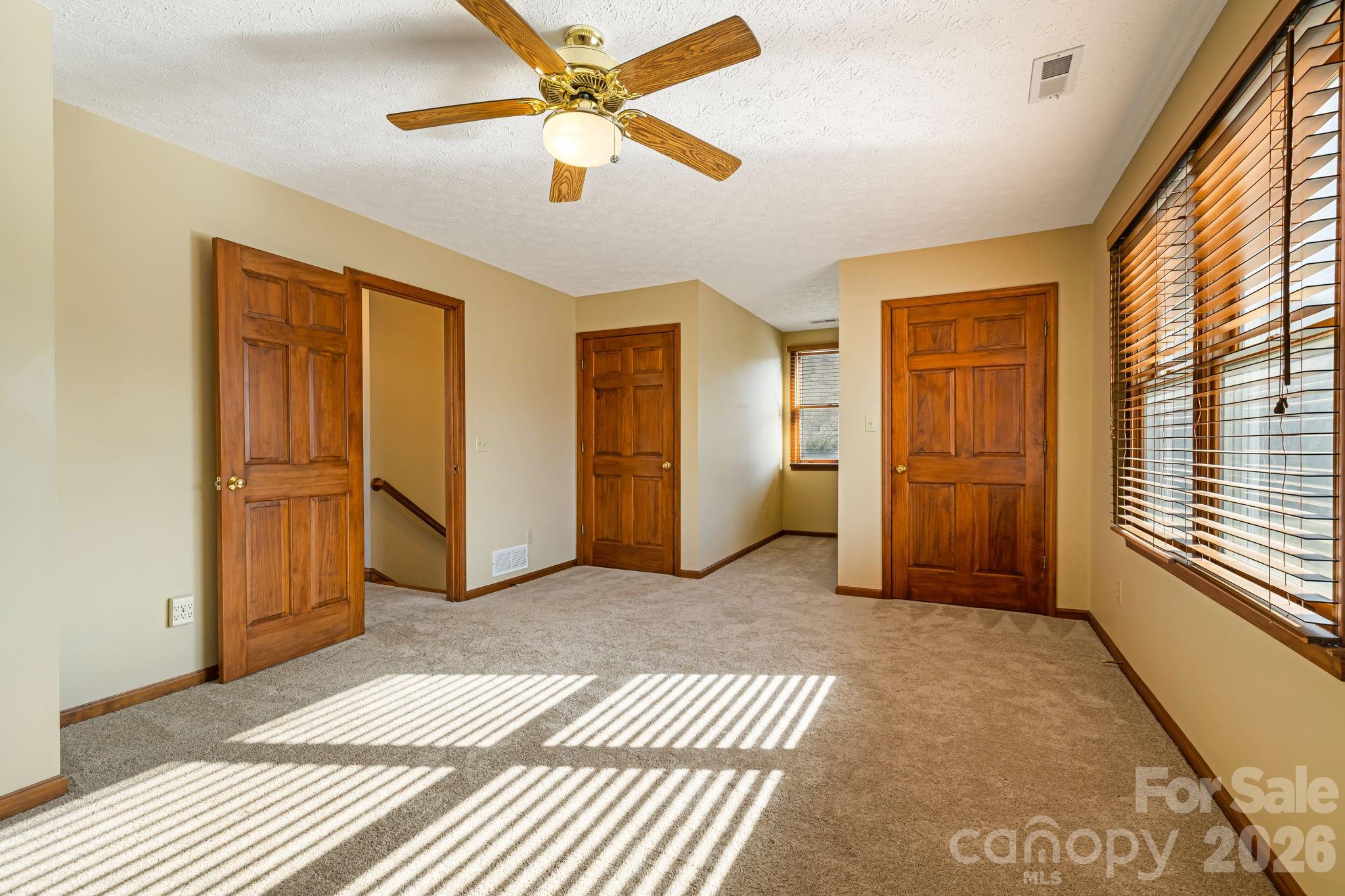 427 McCoy Cove Road Black Mountain, NC 28711 - Photo 24 of 47 a view of a livingroom with wooden floor and a ceiling fan