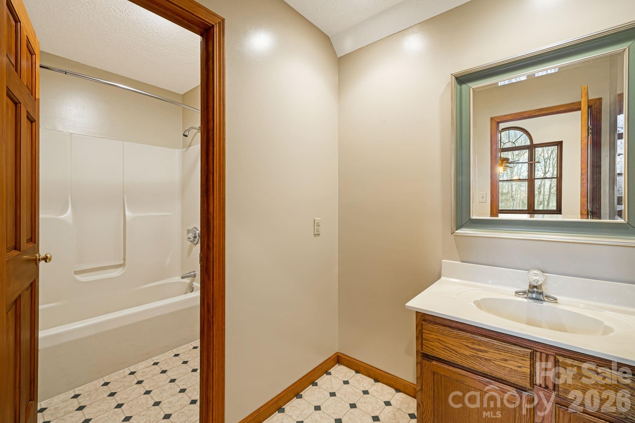 427 McCoy Cove Road Black Mountain, NC 28711 - Photo 27 of 47 a bathroom with a sink a toilet and shower