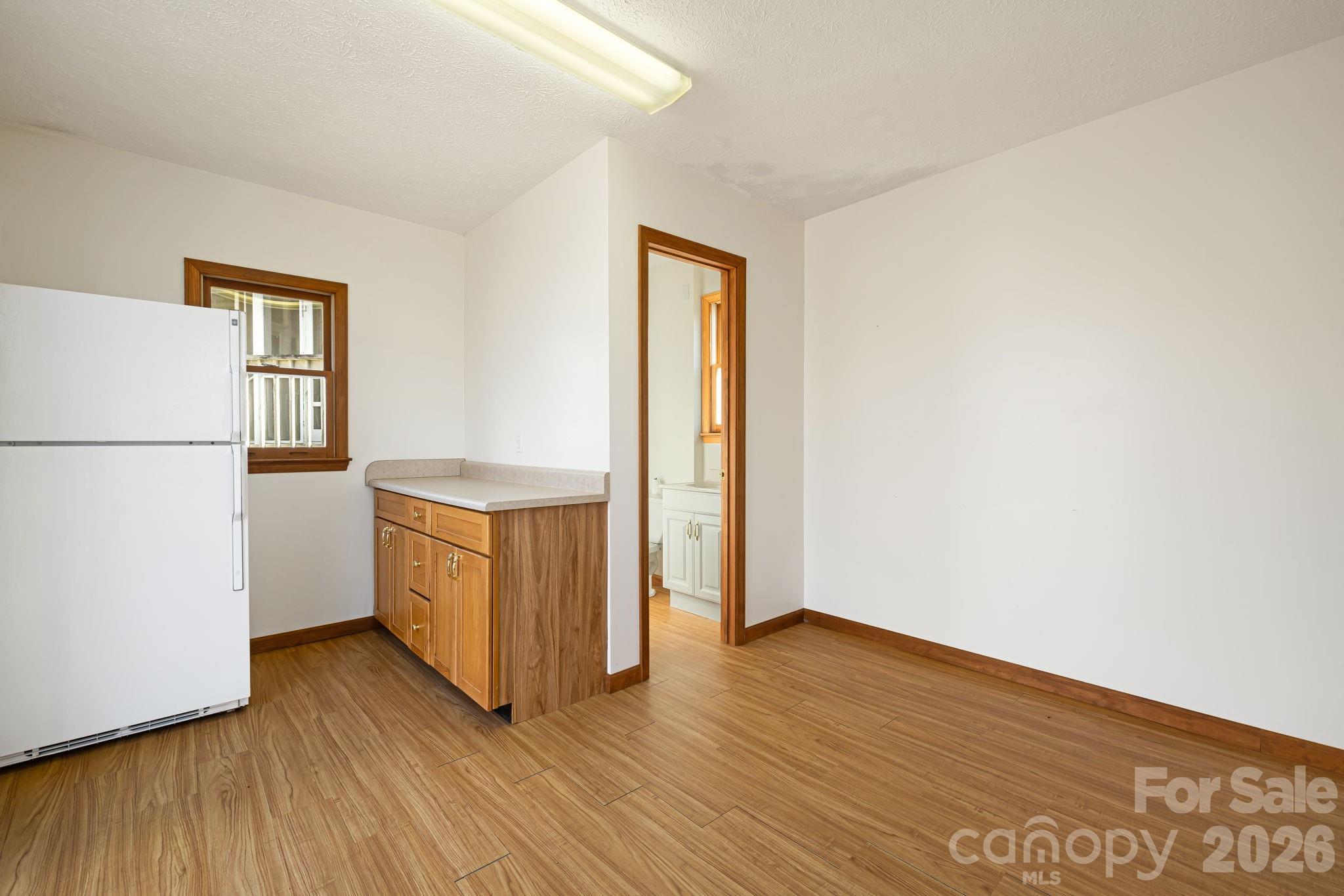 427 McCoy Cove Road Black Mountain, NC 28711 - Photo 36 of 47 a view of a room with wooden floor and a refrigerator