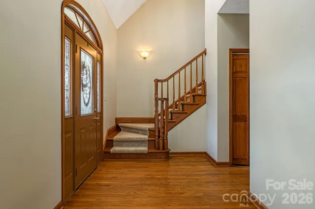 a view of entryway and hall with wooden floor