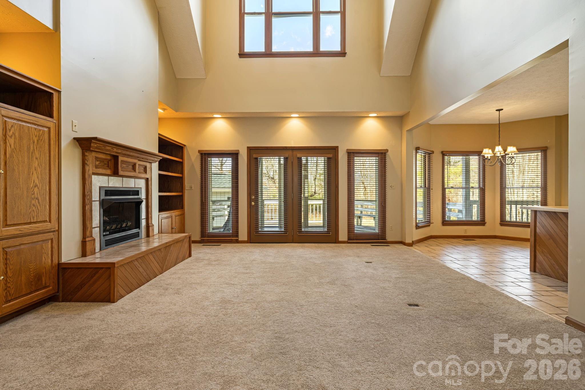 427 McCoy Cove Road Black Mountain, NC 28711 - Photo 9 of 47 a view of an empty room with a fireplace and a window