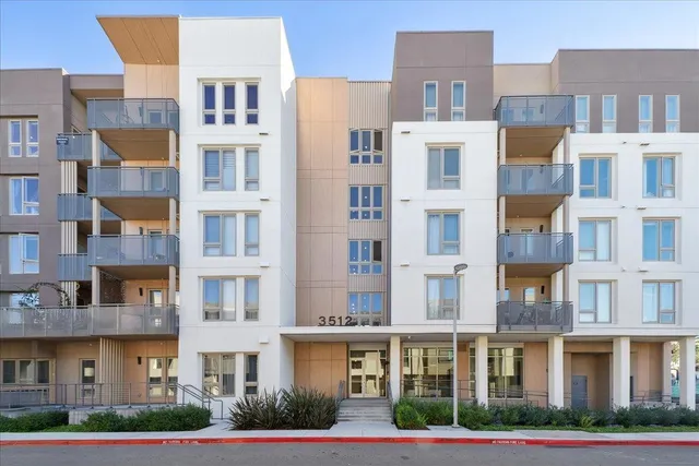 a view of a patio with couches and table and chairs with wooden floor