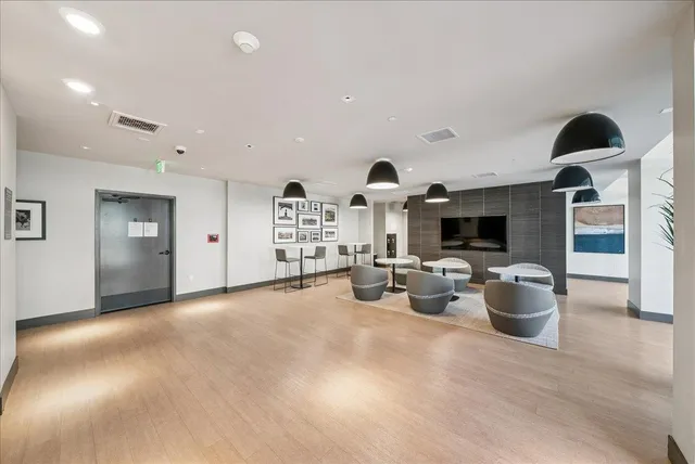 a view of a porch with furniture and wooden floor