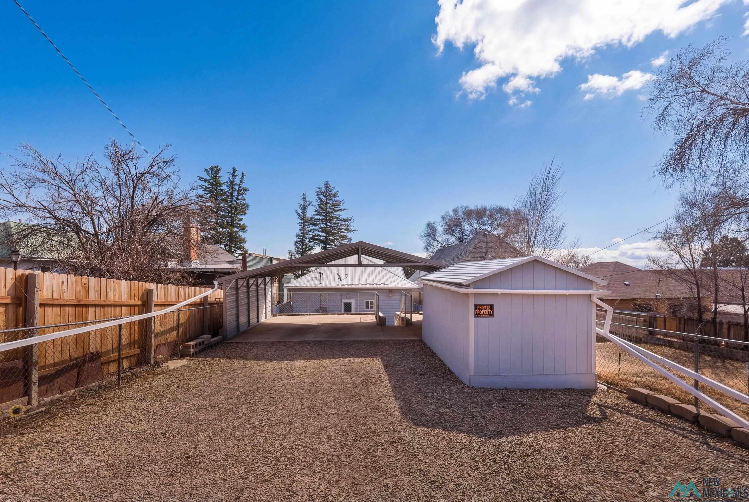 120 South 5th Street Raton, NM 87740 - Photo 24 of 25 Back of house with a fenced backyard and a carport