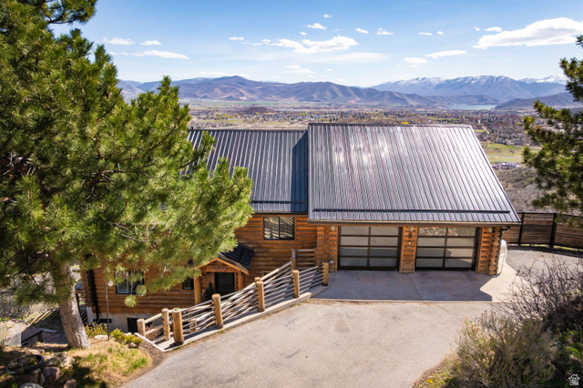 333 Bern Way Midway, UT 84049 - Photo 1 of 1 View of front of home with log siding, driveway, a metal roof, and a mountain view