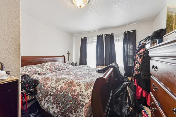 a bed sitting in a bedroom next to a window