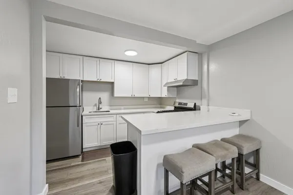 a kitchen with a refrigerator a stove a sink and a refrigerator