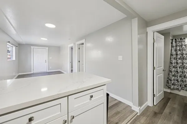 a view of a hallway to closet with wooden floor