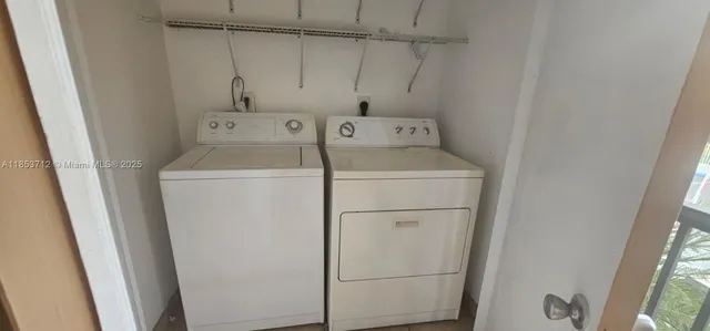 an empty room with windows and glass door