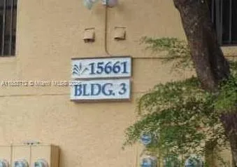 a street sign on a wall next to a wall