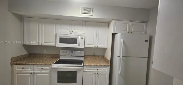 a kitchen with a stove microwave and refrigerator