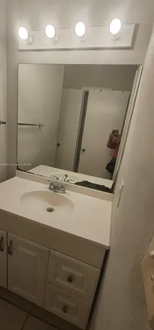 a bathroom with a sink and mirror