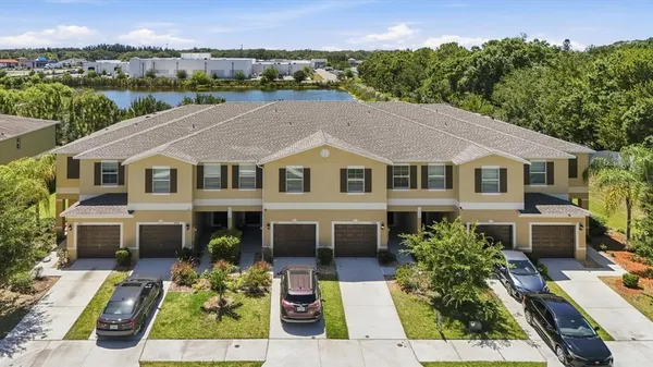 a aerial view of a house with a yard table and chairs