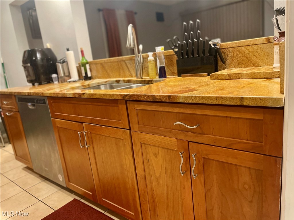 4241 Bluestone Road Cleveland, OH 44121 - Photo 12 of 31 Bar featuring dishwasher, light tile patterned flooring, and sink