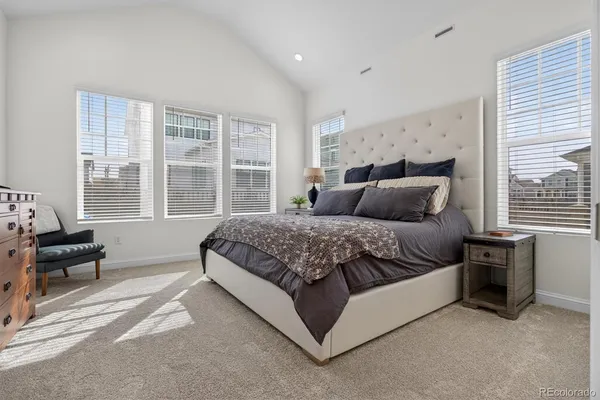 a bedroom with a bed and a dresser next to a window