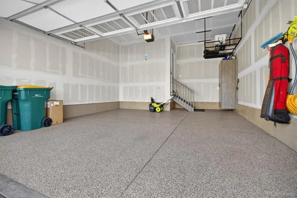 a backyard of a house with dishwasher and wooden fence