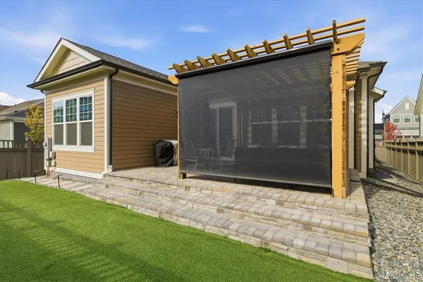 a view of house with yard and deck