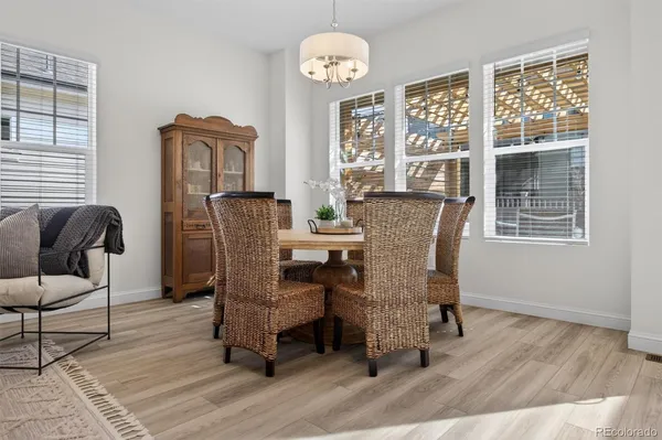 a view of a dining room with furniture window and wooden floor