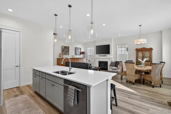 a kitchen with a sink a counter top space a stove and a chandelier