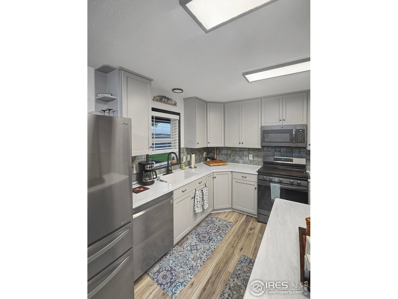 14971 Bluestem Street Sterling, CO 80751 - Photo 10 of 33 a kitchen with a sink cabinets and stainless steel appliances