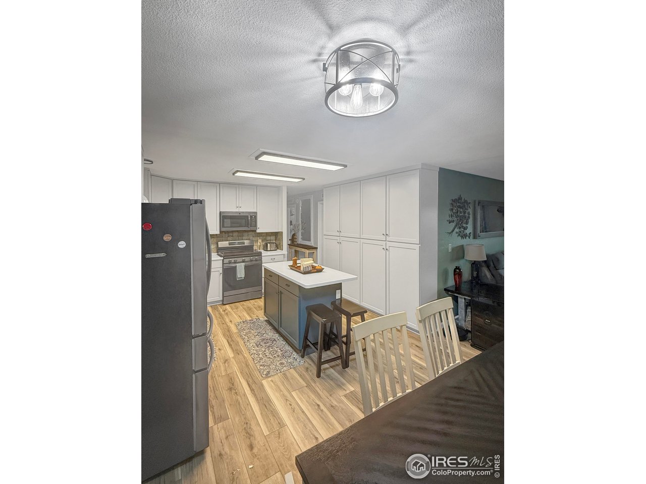 14971 Bluestem Street Sterling, CO 80751 - Photo 11 of 33 a view of a dining room with furniture and a chandelier