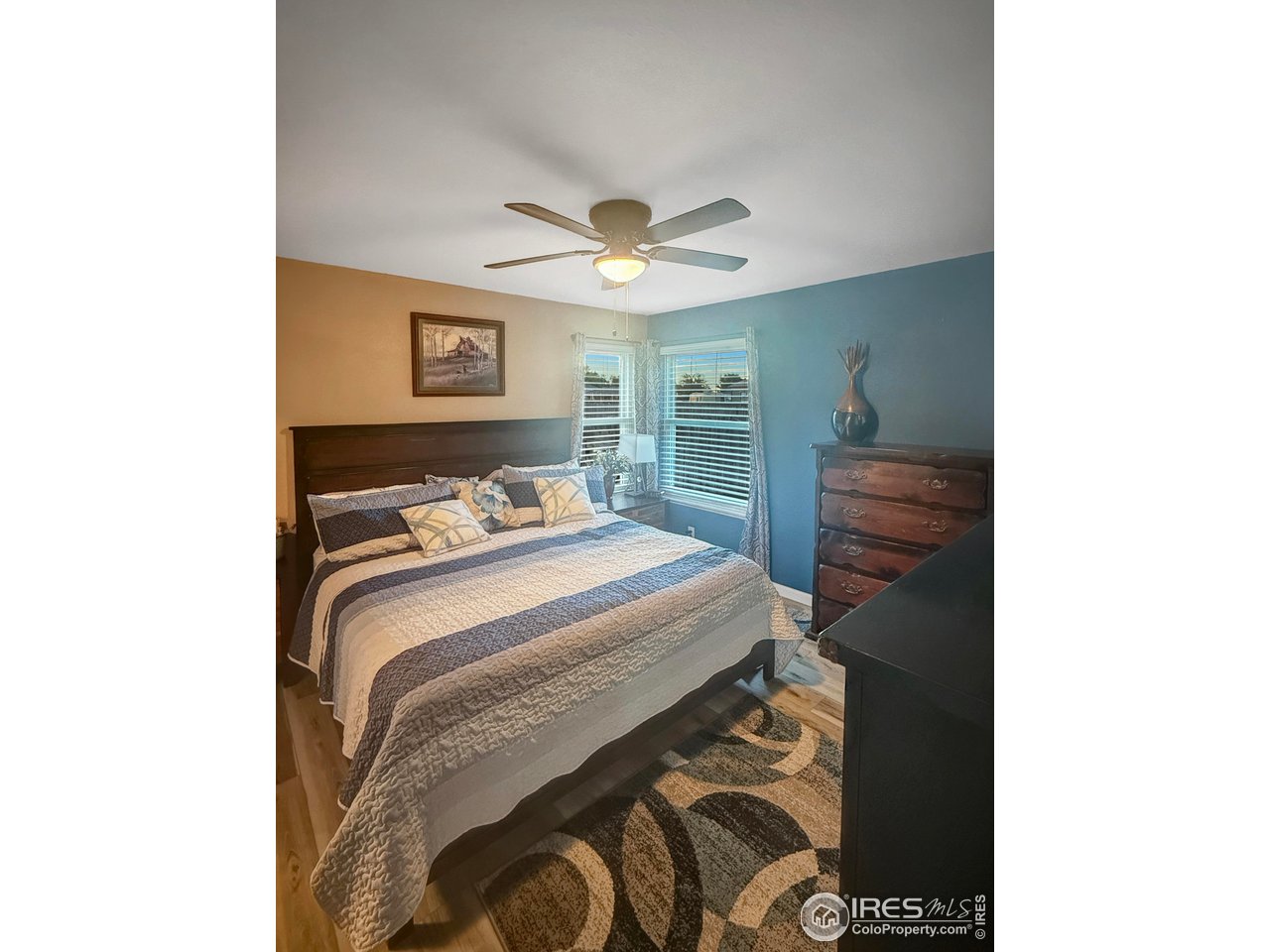 14971 Bluestem Street Sterling, CO 80751 - Photo 12 of 33 a bedroom with a bed and a chandelier