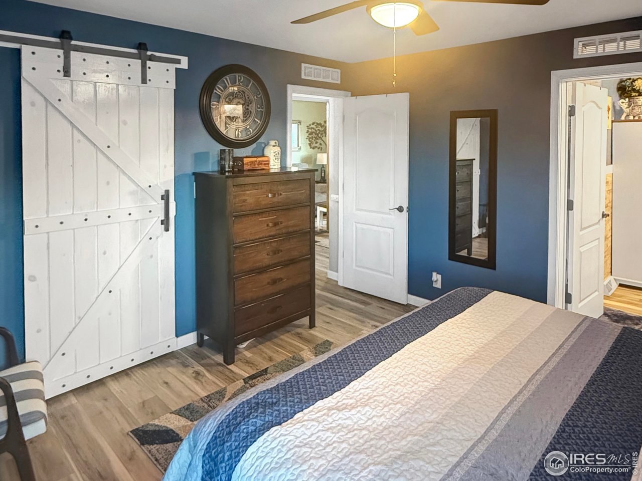 14971 Bluestem Street Sterling, CO 80751 - Photo 13 of 33 a bedroom with a bed a mirror and a window