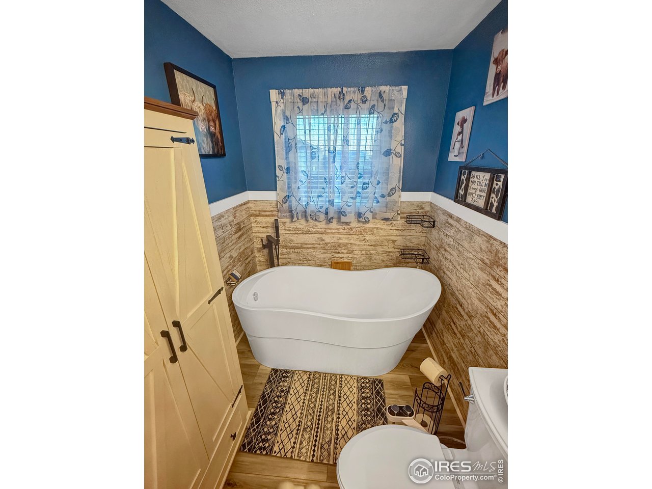 14971 Bluestem Street Sterling, CO 80751 - Photo 14 of 33 a bathroom with a granite countertop sink toilet a mirror and tub