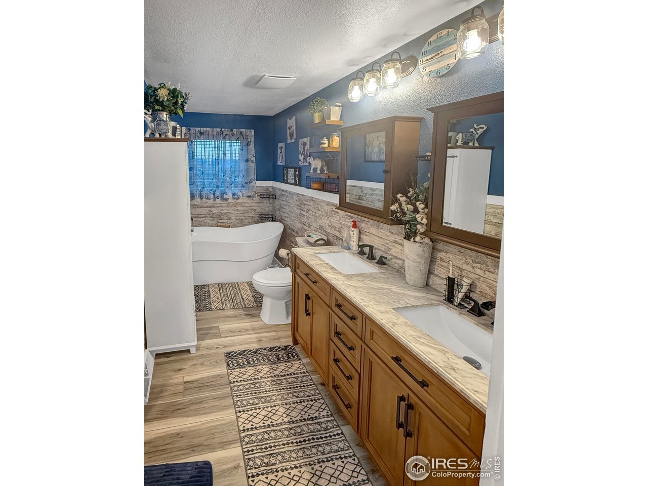 14971 Bluestem Street Sterling, CO 80751 - Photo 16 of 33 a bathroom with a double vanity sink and a mirror