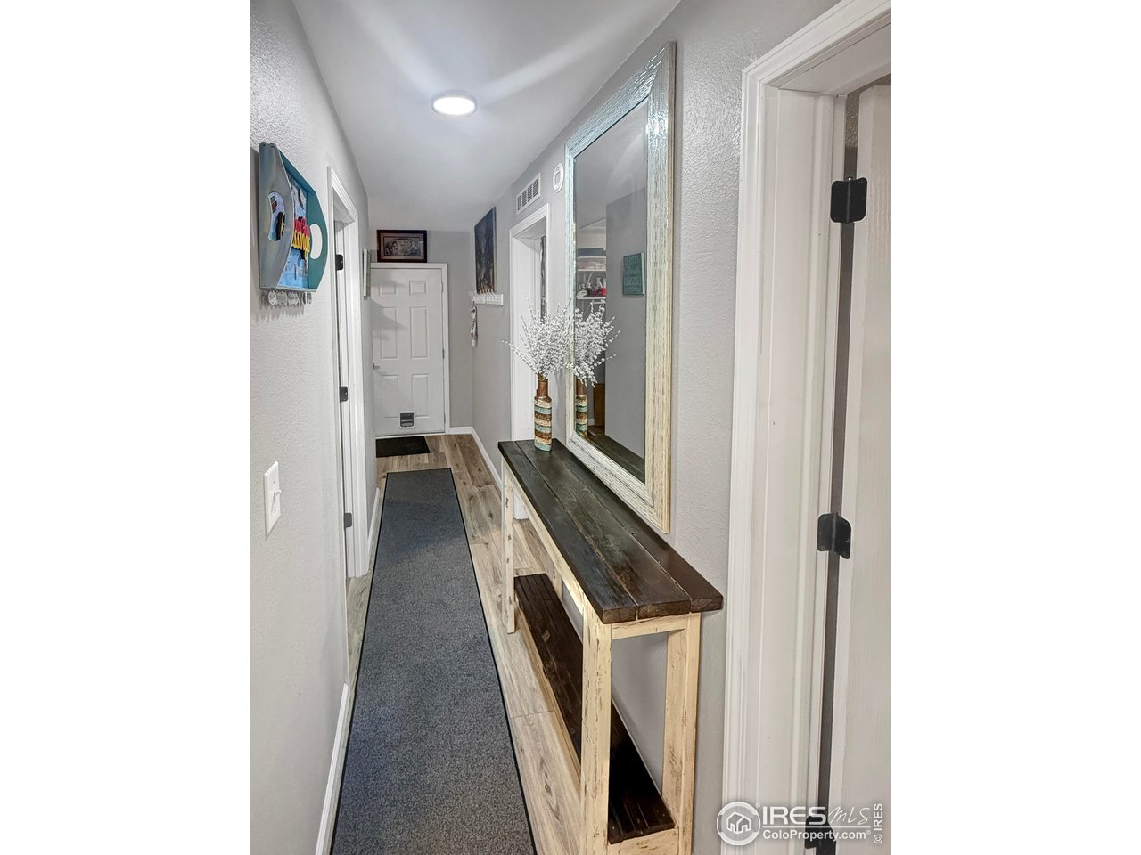 14971 Bluestem Street Sterling, CO 80751 - Photo 18 of 33 a view of a hallway with wooden floor