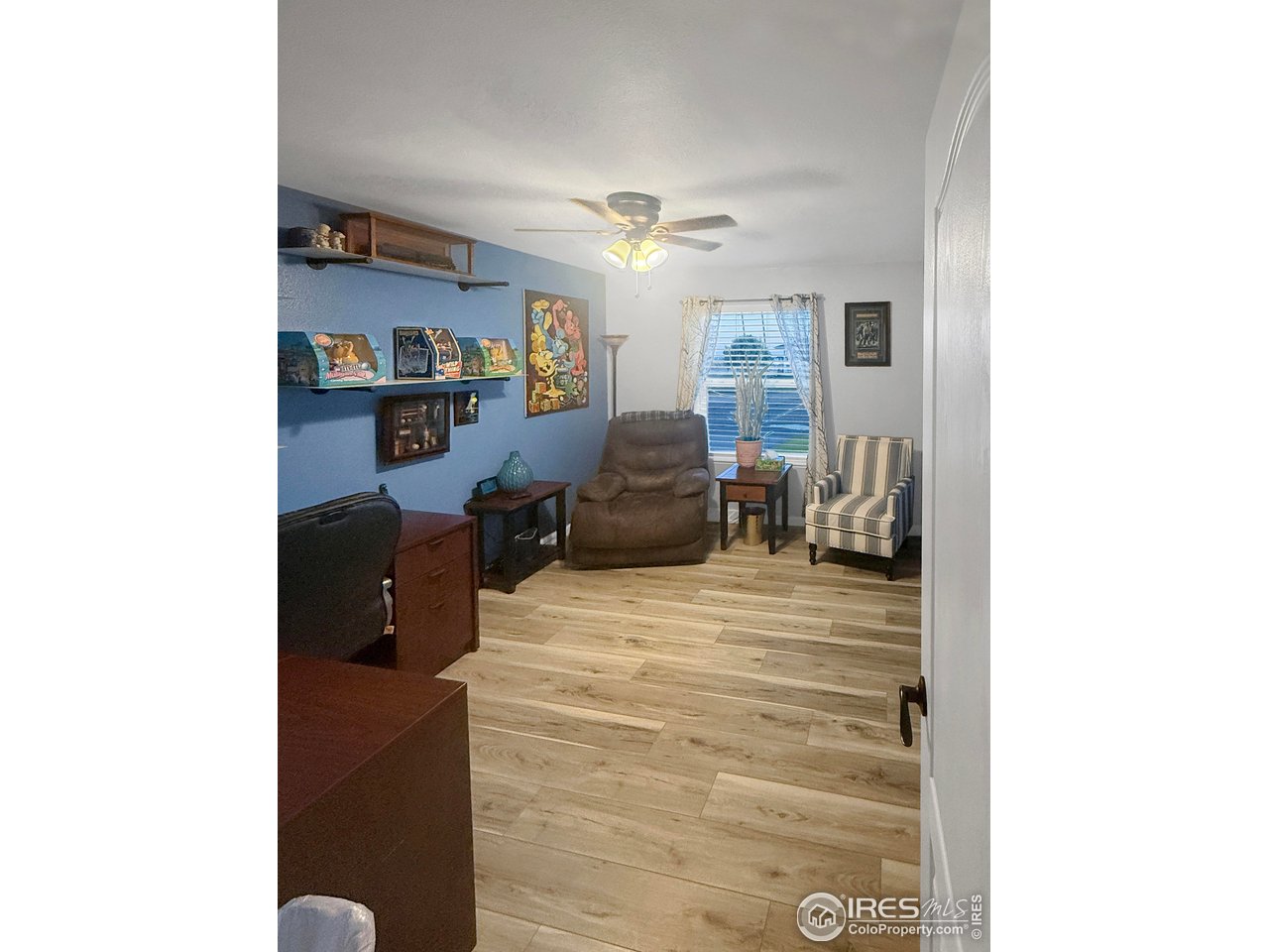 14971 Bluestem Street Sterling, CO 80751 - Photo 19 of 33 a living room with furniture and a lamp