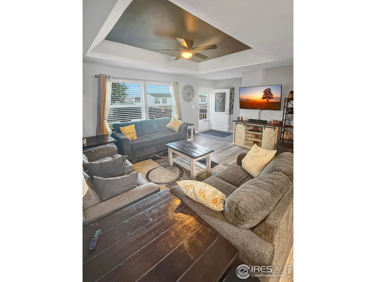 14971 Bluestem Street Sterling, CO 80751 - Photo 7 of 33 a living room with furniture and a flat screen tv