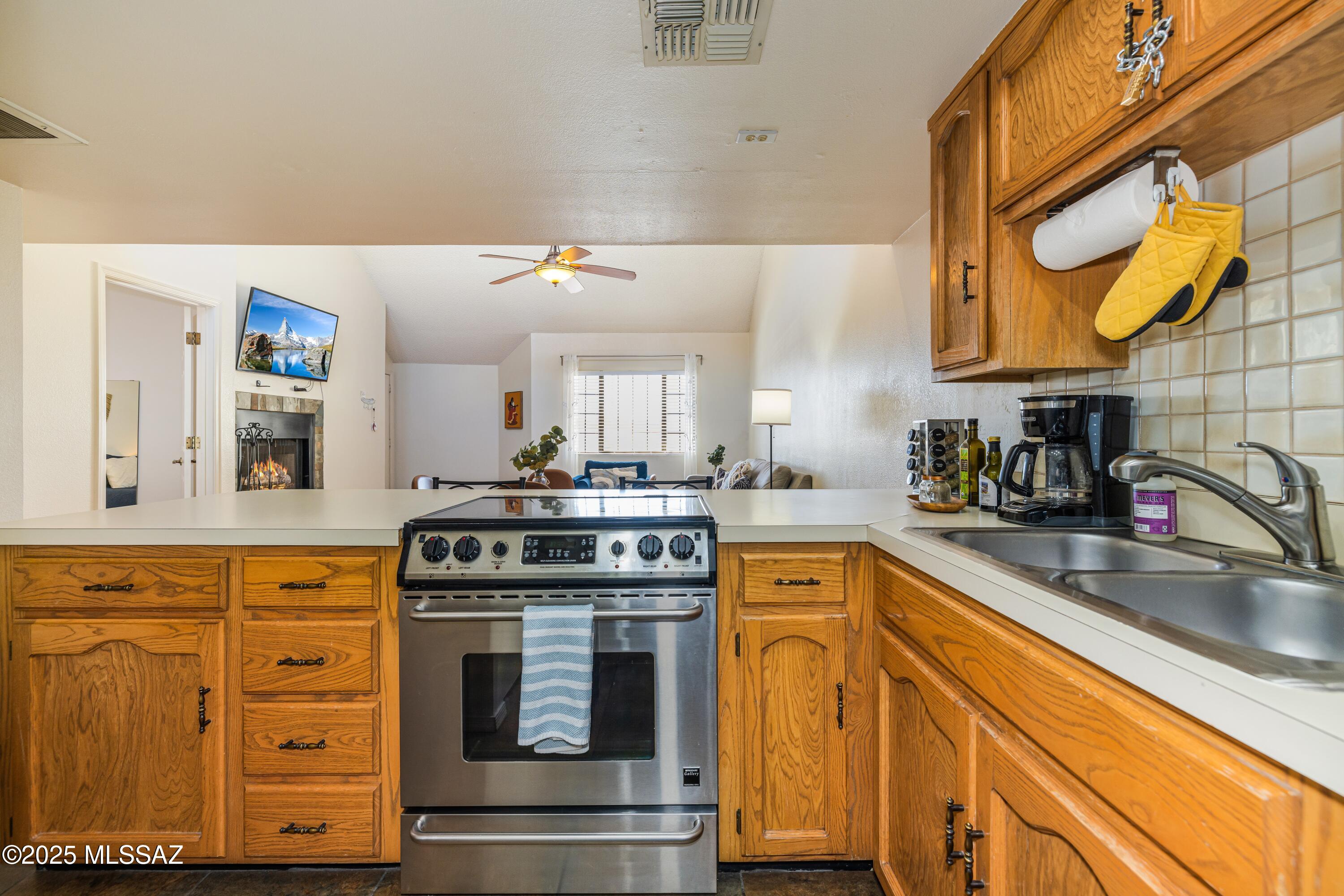 1200 East River Road, Unit G88 Tucson, AZ 85718 - Photo 4 of 13 a kitchen with stainless steel appliances granite countertop a sink and cabinets